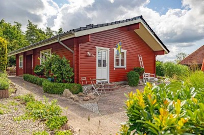 Dänisches Holzhaus auf einer Ebene in dörflicher Lage