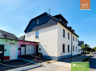 Zweifamilienhaus mit Maisonettewohnung, Ladenlokal, Garten, Terrasse, Garagen und Stellplätzen