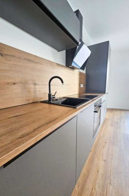 NEUBAU-ERSTBEZUG: 2-Zimmer-Wohnung mit Balkon, neuer Einbauküche, Tageslichtbad und Tiefgarage