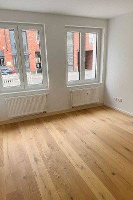 Erstbezug: 3-Zimmer-EG-Wohnung mit Einbauküche, neuem Echtholzboden, Energieklasse A & Wärmepumpe