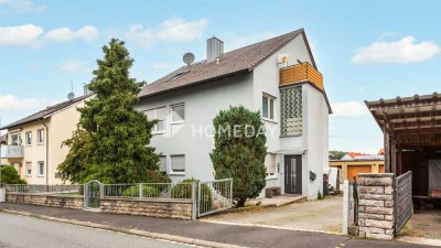 Vielseitiges Einfamilienhaus mit zwei Wohneinheiten, Garagen und Nebengebäude in ruhiger Lage